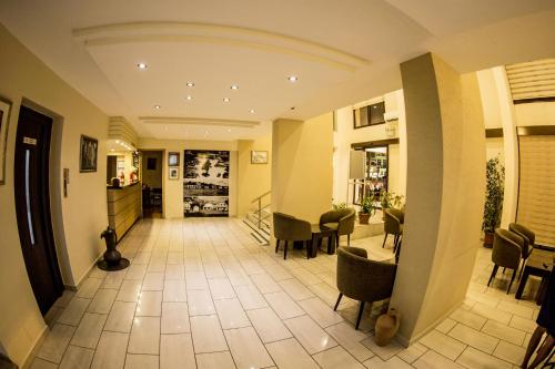 a hallway with chairs and tables in a building at Rıdvan Hotel in Cesme