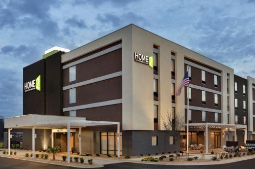 a hotel building with an american flag in front of it at Home2 Suites By Hilton Macon I-75 North in Macon