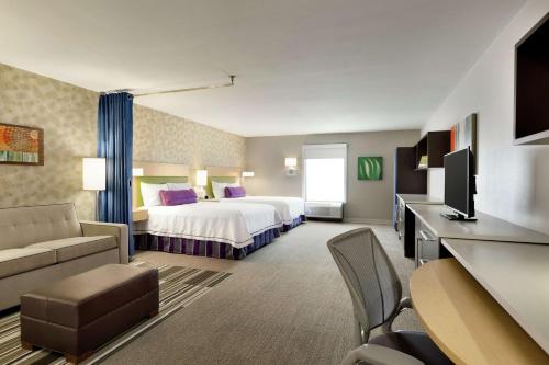 a hotel room with a bed and a couch at Home2 Suites By Hilton Macon I-75 North in Macon