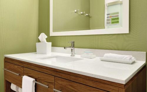 a bathroom with a sink and a mirror at Home2 Suites By Hilton Macon I-75 North in Macon