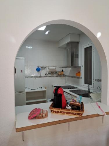 a kitchen with an archway in the middle of it at Apartamento San Jose in San José