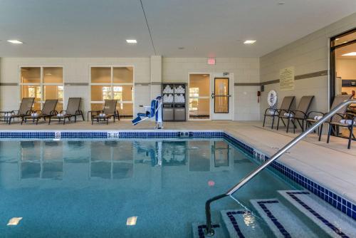 a large swimming pool with chairs and tables at Hampton Inn Brighton Mi in Brighton