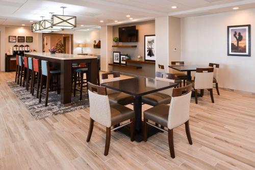 a dining room and kitchen with a table and chairs at Hampton Inn El Centro in El Centro