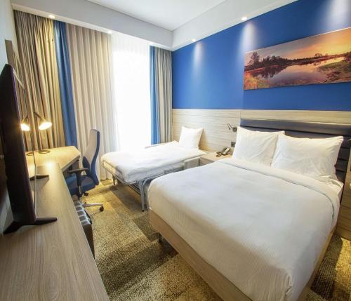 a hotel room with two beds and a tv at Hampton By Hilton Bolu in Bolu