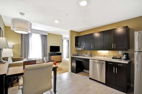 a kitchen and living room with a dining room at Homewood Suites By Hilton Augusta Gordon Highway in Augusta