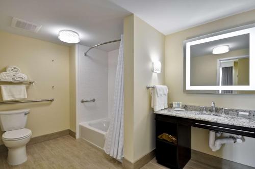 a bathroom with a toilet and a sink and a tub at Homewood Suites By Hilton Augusta Gordon Highway in Augusta