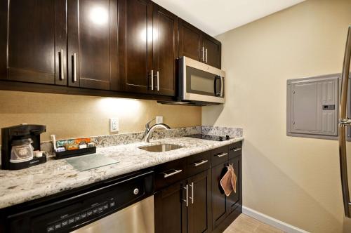 a kitchen with a sink and a microwave at Homewood Suites By Hilton Augusta Gordon Highway in Augusta