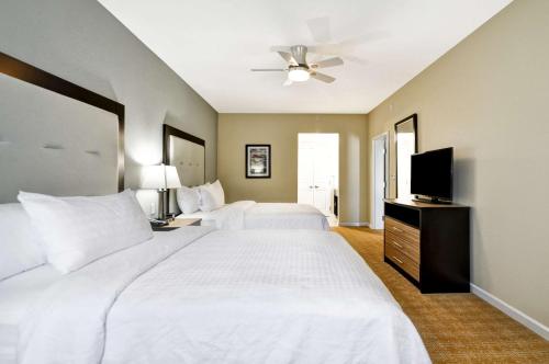 a bedroom with two beds and a flat screen tv at Homewood Suites By Hilton Augusta Gordon Highway in Augusta