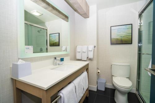 a bathroom with a sink and a toilet at Four Points by Sheraton Salt Lake City Airport in Salt Lake City