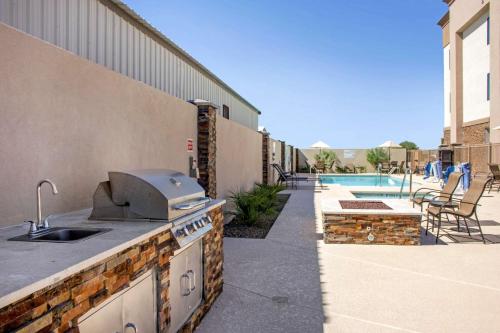 a outdoor kitchen with a grill next to a pool at Hampton Inn Parker, AZ in Parker