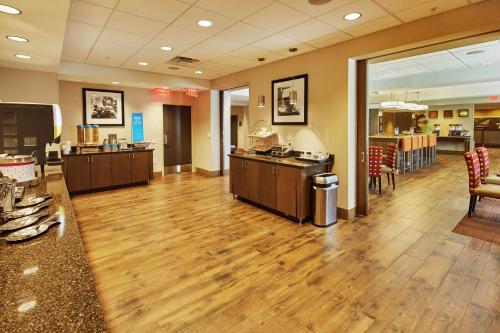 a large lobby with a hard wood floor and a restaurant at Hampton Inn Parker, AZ in Parker