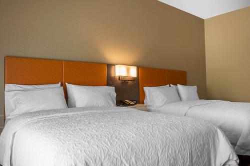 two beds in a hotel room with white pillows at Hampton Inn Parker, AZ in Parker