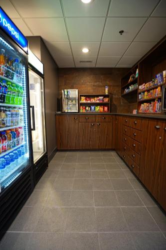 a grocery store aisle with a drink cooler in a store at Four Points by Sheraton Salt Lake City Airport in Salt Lake City