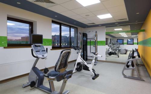 a gym with treadmills and ellipticals in a building at Hampton By Hilton Astana Triumphal Arch in Astana