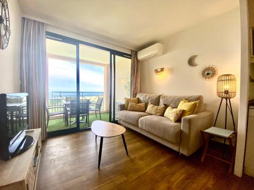 d'un salon avec un canapé et un balcon. dans l'établissement Les Ingres By SCLS Locations, à Cannes