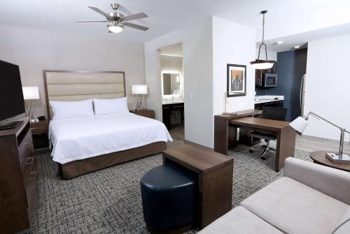 a hotel room with a bed and a desk and a computer at Homewood Suites By Hilton West Fargo/Sanford Medical Center in Fargo