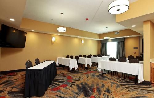 a conference room with tables and chairs and a flat screen tv at Homewood Suites By Hilton West Fargo/Sanford Medical Center in Fargo