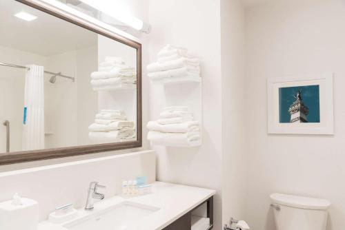 a white bathroom with a sink and a mirror at Hampton Inn & Suites Indianapolis-Keystone, IN in Indianapolis