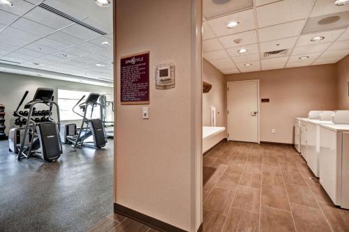 a gym with exercise equipment and a sign on the wall at Home2 Suites by Hilton Springfield North in Springfield