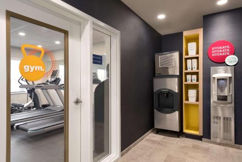 a fitness room with a gym with a treadmill at Tru By Hilton Cedar Rapids Westdale in Cedar Rapids