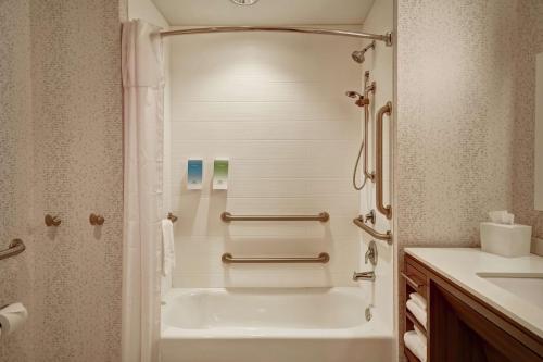 a bathroom with a bath tub and a sink at Home2 Suites by Hilton Springfield North in Springfield