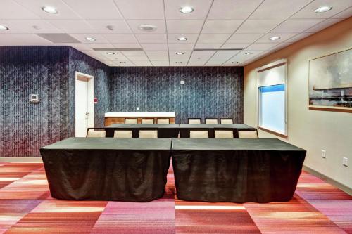 a conference room with a large table and chairs at Home2 Suites by Hilton Springfield North in Springfield