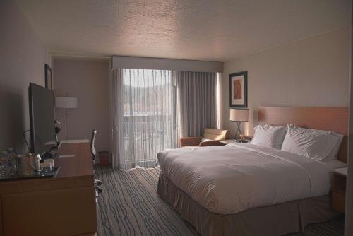 a hotel room with a bed and a television at Doubletree By Hilton Helena Downtown in Helena