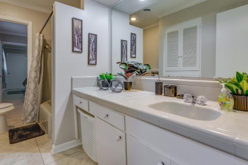 a bathroom with a sink and a mirror at Spacious Little Rock Home with Patio - 9 Mi to Dtwn! in Little Rock