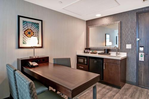 a conference room with a table and a sink at Embassy Suites By Hilton Plainfield Indianapolis Airport in Plainfield
