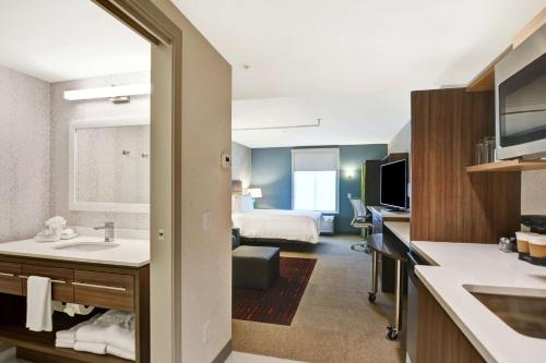a hotel room with a bed and a bathroom at Home2 Suites By Hilton Beaufort in Beaufort
