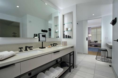 a bathroom with a sink and a large mirror at Canopy By Hilton Columbus Downtown Short North in Columbus