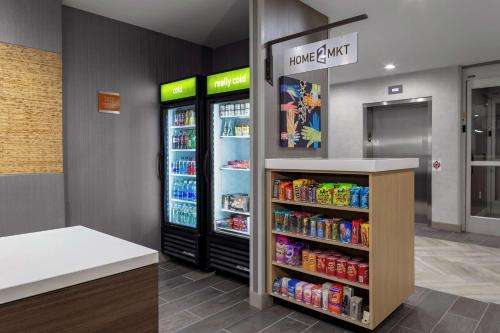a store with two refrigerators with drinks in it at Home2 Suites By Hilton Salisbury in Salisbury