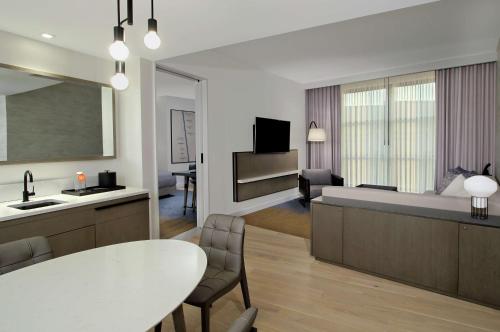 a kitchen and living room with a bed and a table at Canopy By Hilton Columbus Downtown Short North in Columbus