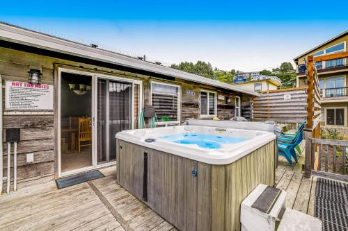 a hot tub on the deck of a house at The Lucky Starfish in Lincoln City
