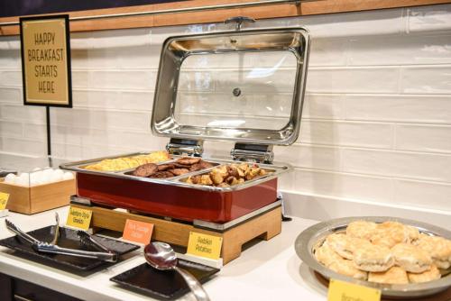 a buffet with various types of pastries on a counter at Hampton Inn & Suites Lenoir, NC in Lenoir