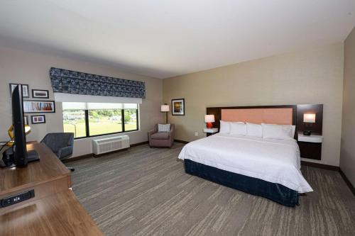 a hotel room with a bed and a flat screen tv at Hampton Inn & Suites Lenoir, NC in Lenoir