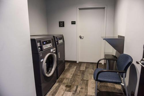 a laundry room with a washing machine and a door at Hampton Inn & Suites Lenoir, NC in Lenoir