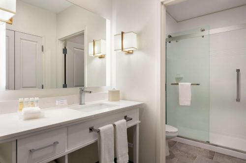 a bathroom with a sink and a toilet and a mirror at Homewood Suites By Hilton Horsham Willow Grove in Horsham