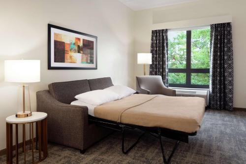 a room with a bed and a couch and a window at Homewood Suites By Hilton Horsham Willow Grove in Horsham