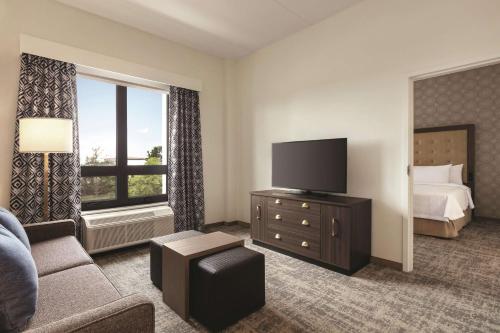 a hotel room with a bed and a television at Homewood Suites By Hilton Horsham Willow Grove in Horsham