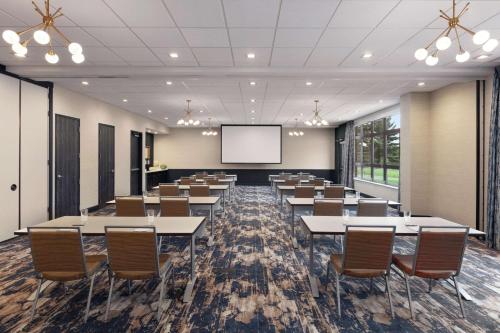 a conference room with tables and chairs and a screen at Homewood Suites By Hilton Horsham Willow Grove in Horsham