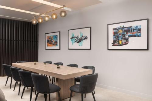 a conference room with a wooden table and chairs at Hilton Garden Inn Silverstone in Towcester