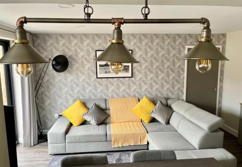 a living room with a couch and two lights at Modern 2BR Flat in Sale - Peaceful Stay in M33 - Great Transport Links in Broadheath