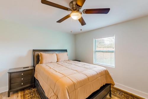 a bedroom with a bed and a ceiling fan at Just for Sun in Jacksonville