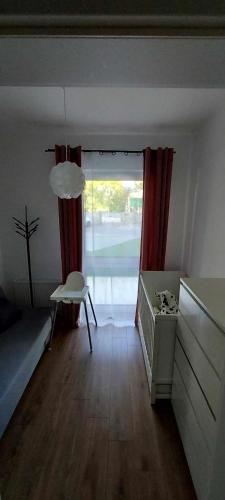a living room with a bed and a window at Apartament z tarasem Kutno in Kutno