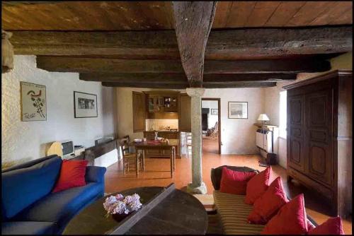 a living room with a blue couch and red pillows at Agriturismo Famiglia al Castello Di Bagnolo in Bagnolo Piemonte