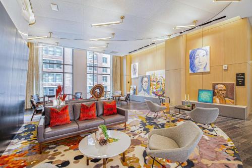 a living room with a couch and chairs at Canopy By Hilton Jersey City Arts District in Jersey City