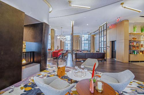 a living room with a table and chairs at Canopy By Hilton Jersey City Arts District in Jersey City