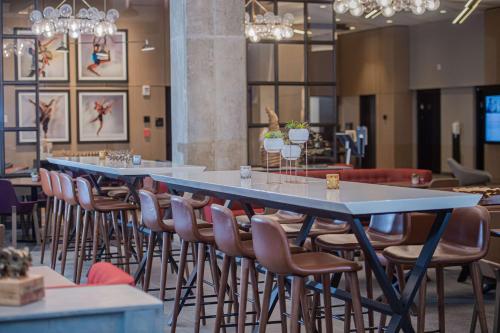 a group of tables and chairs in a restaurant at Canopy By Hilton Jersey City Arts District in Jersey City
