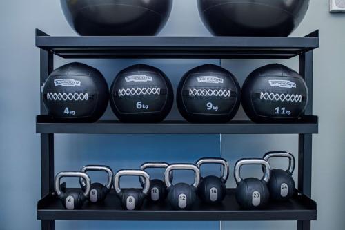 a shelf with dumbbells on it at Canopy By Hilton Jersey City Arts District in Jersey City